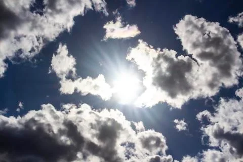 A clouds in the blue sky. Sun light. God light. Stock Photos