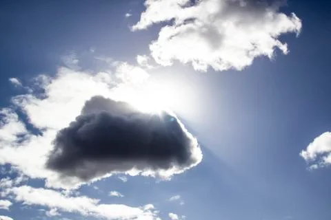 Clouds in the blue sky with a sun light. A miracle Gods light against backgro Stock Photos