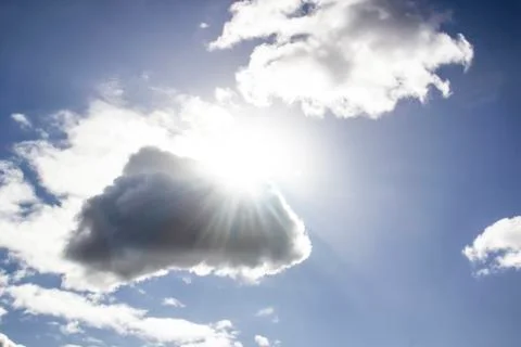 Clouds in the blue sky with a sun light. A miracle Gods light against backgro Stock Photos