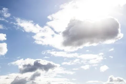 Clouds in the blue sky with a sun light. A miracle Gods light against backgro Stock Photos