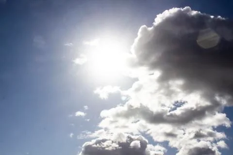 Clouds in the blue sky with a sun light. A miracle Gods light against backgro Stock Photos
