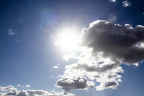 Clouds in the blue sky with a sun light. A miracle Gods light against backgro Stock Photos
