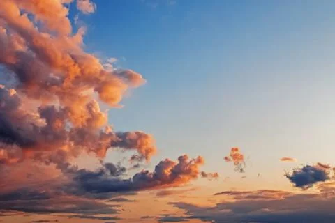 Clouds on the blue sky in sunset light. Stock Photos