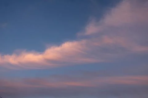 Clouds in the blue sky with white pink clouds on a summer evening on the eve  Stock Photos