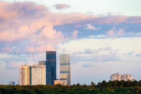 Clouds in blue sunset sky over city skyscrapers Stock Photos