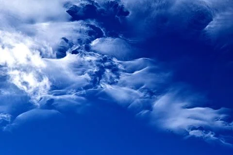 Clouds on a bright blue sky Stock Photos