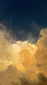 Clouds with a bright yellow sunset sky and dark blue Stock Photos