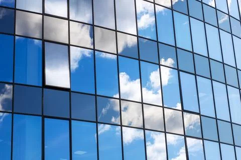 The clouds can be seen beautifully reflected in the glass windows of a building Foto stock