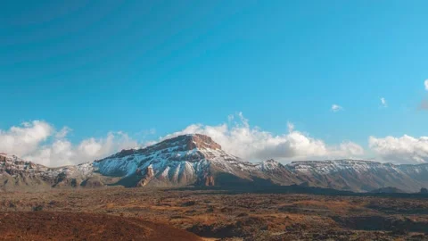 Clouds cascading over snowy Mount Guajara peak, 4K timelapse in Teide National P Stock Footage 332480648