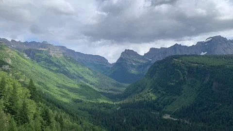Clouds cast shadows passing over mountain valley Stock Footage 113951212