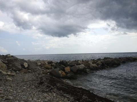 The clouds, cataclysm, coast over the Black sea beach Stock Photos