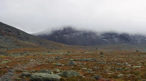 The clouds caught on the tops of the mountains. Low clouds in the mountains.  Stock Photos