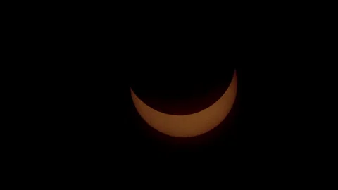 Clouds clear to reveal solar eclipse during partial phase. Stock Footage 272407044