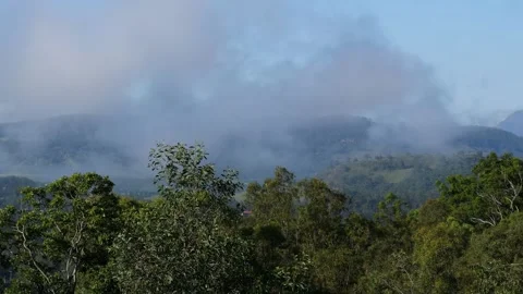 Clouds Clearing Over Verdant Hillside Stock Footage 311442680