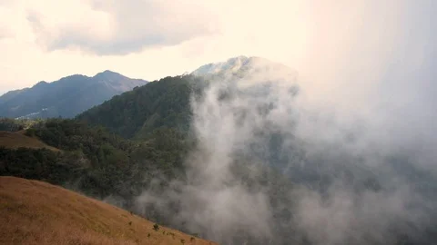 Clouds clearing to reveal a mountain view Stock Footage 102352560