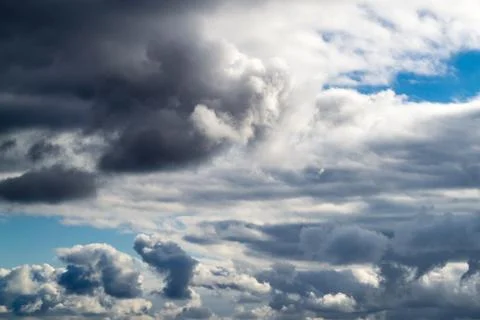 Clouds close up. Dark gray clouds at sunny day. Natural background. Stock Photos