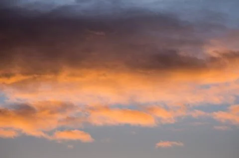 Clouds colored by sunrise Stock Photos