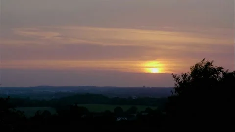 Clouds consume a setting sun Stock Footage 133464364