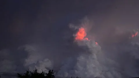 Clouds convecting during a thunderstorm. Fiery patch of sun lighting up clouds Stock Footage 239719870