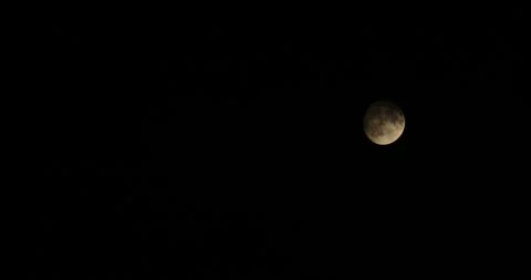 Clouds cover the moon in the night sky Stock Footage 247715498