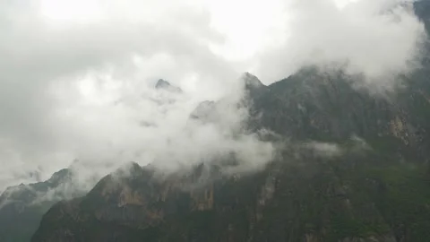 Clouds cover the mountains of the Tiger Leaping Gorge, in China Stock Footage 232170495