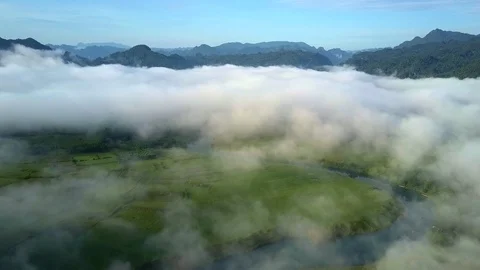 Clouds cover valley with river and bizarre hills against sky Video stock 93819835