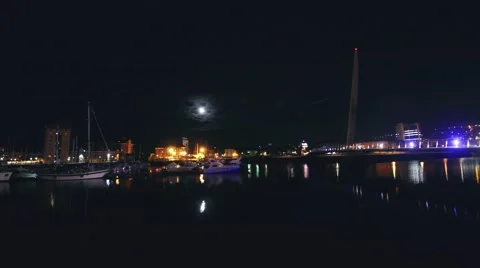 Clouds covering moon over marina Stock Footage 65062258