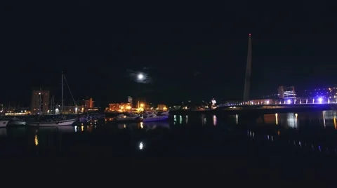 Clouds covering moon over water reflection of bridge and boats Stock-Footage 66777286