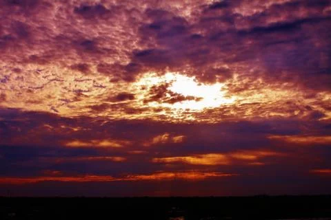 Clouds covering the sun s rays in the sky Stock Photos