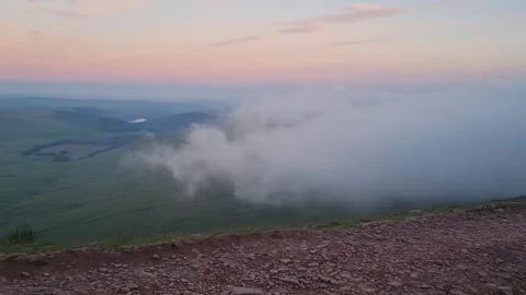 Clouds creep in from mountain top Stock Footage 288526361