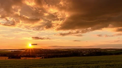 Clouds crossing on sunset sky over small town time lapse Stock Footage 245542246