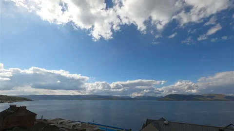 Clouds Dance Over A River And A Small Town. Video stock 172060303