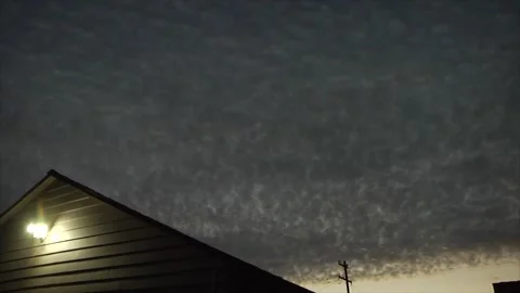 Clouds to darkness, sunset, porch light turning off, timelapse Stock Footage 144646924