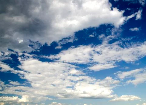 Clouds in deep blue summer sky Stock Photos