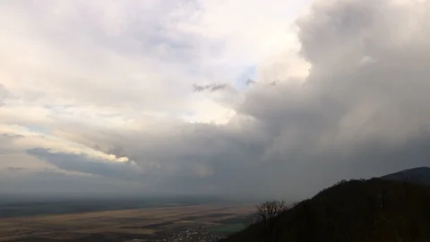 The clouds depart in time lapse over the hills and plains Video stock 125444796