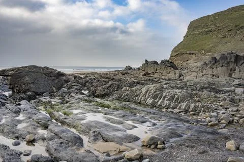 Clouds disperse over Duckpool in Cornwall Fotos Stock