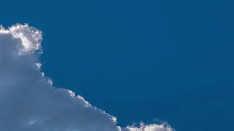 Clouds dissipating and moving away, clearing the blue sky, timelapse Stock Footage 162715485