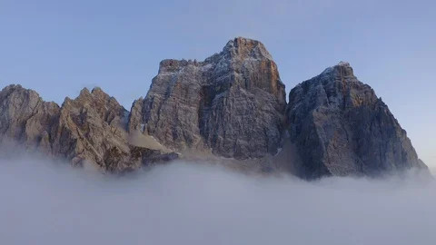 Clouds dissolving in the sky and the Pelmo mountain behind, Italian Dolomites Stock Footage 129813729