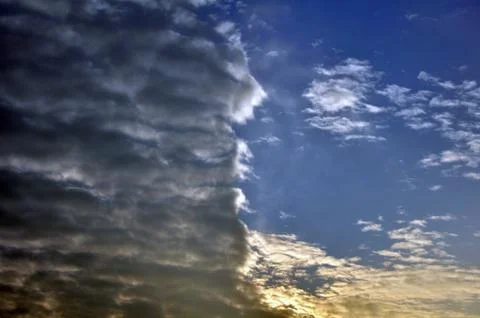 Clouds divided sky sunset colorful light dark Stock Photos