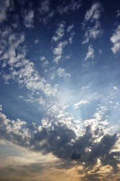 Clouds, dramatic blue sky and sunlight before sunset. Stock Photos