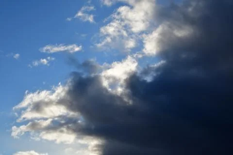 Clouds with dramatic clouds against a blue cloudy sky. Stock Photos