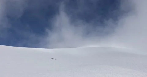 Clouds dramatically flow around the mountains in a ski resort. Video stock 177368797