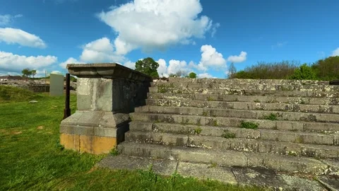 Clouds drift above mossy grass. Felix Romuliana, Jupiter Temple Stock Footage 335298861