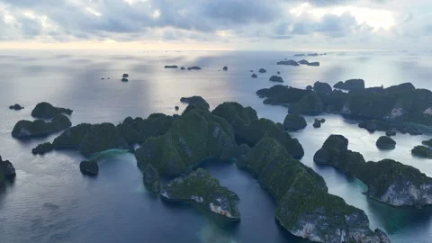 Clouds Drift Above Rock Islands at Dawn in Raja Ampat Stock Footage 307222356