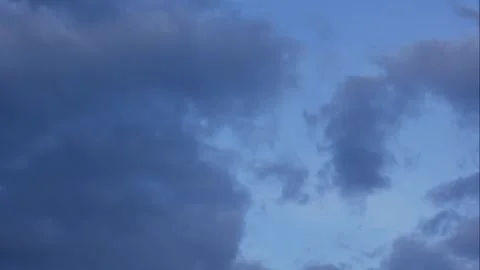 Clouds drift across a clear blue sky in a smooth timelapse as soft daylight Stock Footage 323439015