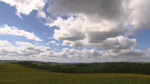 Clouds drift across the sky over meadows in spring Stock Footage 271361647