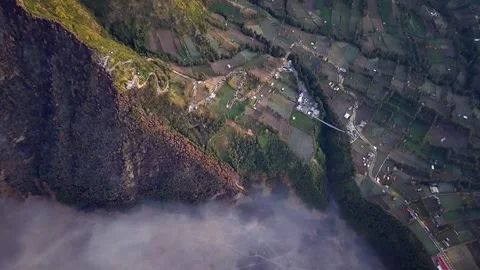 Clouds drift below steep cliffs Vídeo Stock 346919955