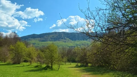 Clouds drift lazily across a vivid blue sky. Near Rosomac Canyon, Serbia Stock Footage 335535006