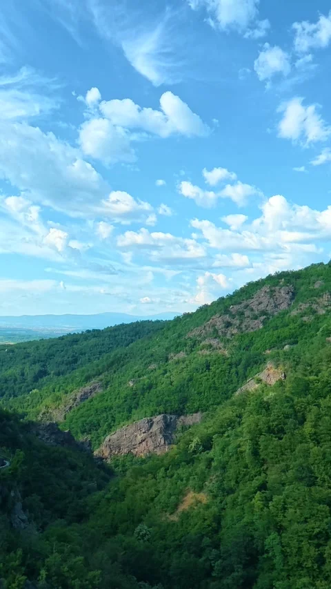 Clouds drift lazily over rugged. Sokolica rock, Serbia. Vertical Stock Footage 341131859