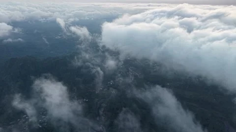 Clouds drift over forested hills Stockbeeldmateriaal 346913172